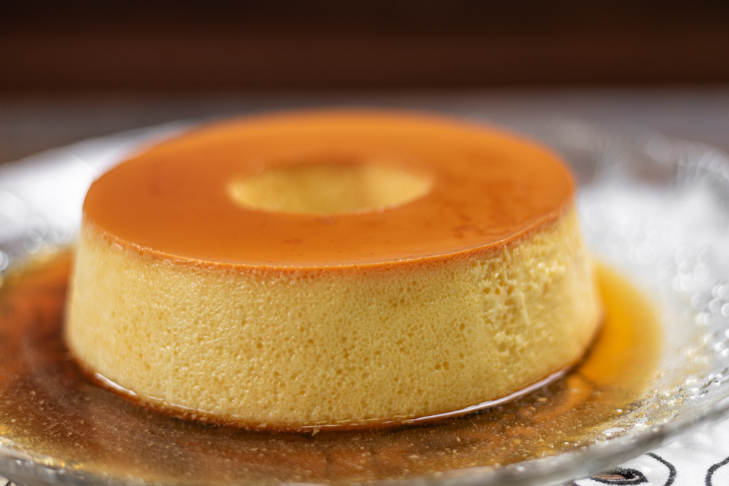 Milk Pudding or Pudim de leite. Brazilian dessert homemade caramel custard pudding. Traditional brazilian flan on wooden background